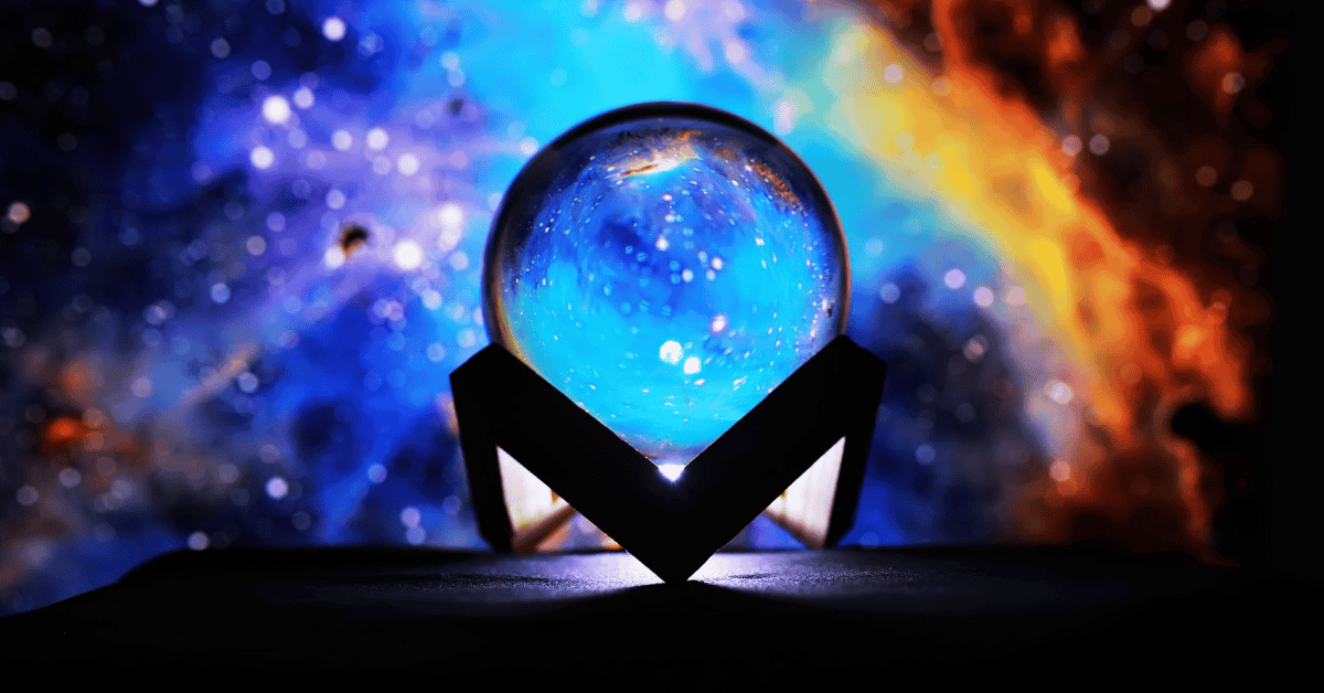 a crystal ball with a rainbow cosmic background