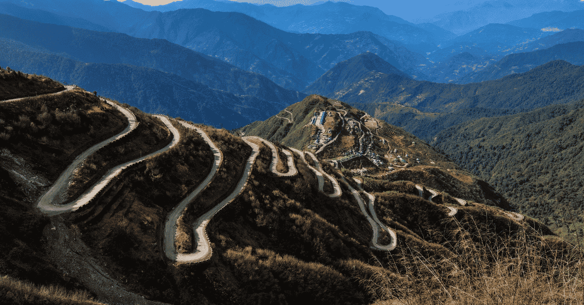 A winding mountain road representing the journey of nervous system regulation and healing emotional wounds